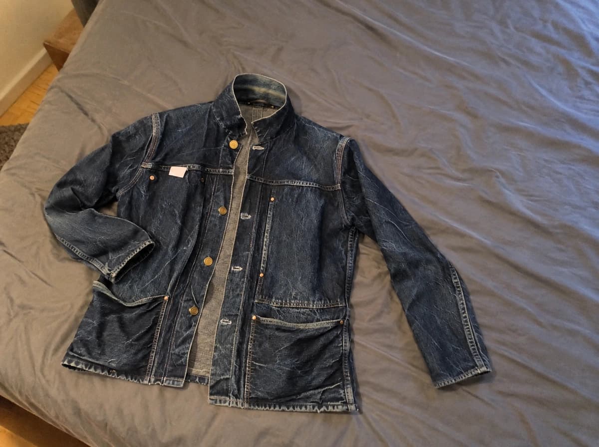 Avant ajusté pour la démonstration : Veste en jean posée de travers sur un drap froissé